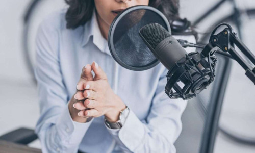 Female talking on microphone for radio