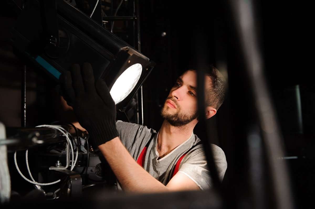 film crew fixing set lighting